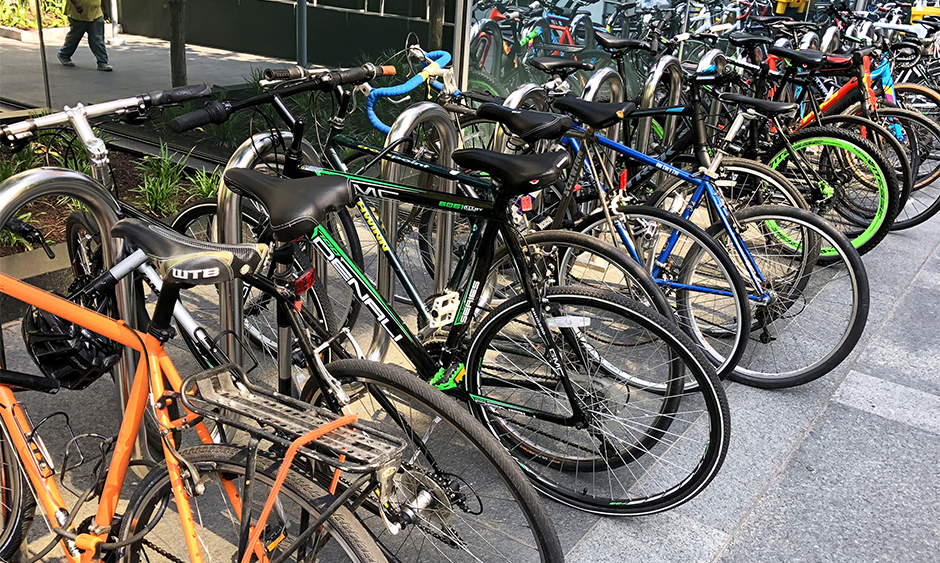A photo of bicycles parked in a bike rack