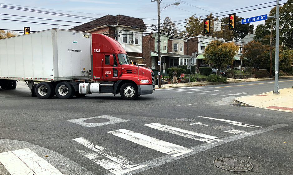 A semi truck driving in a residential area