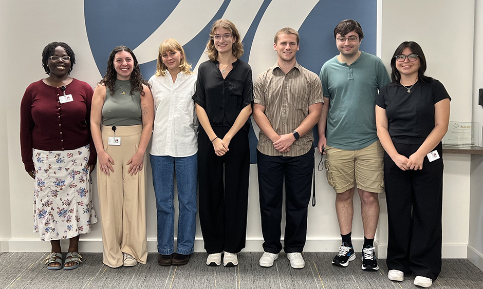 A group of people stand together for a photo