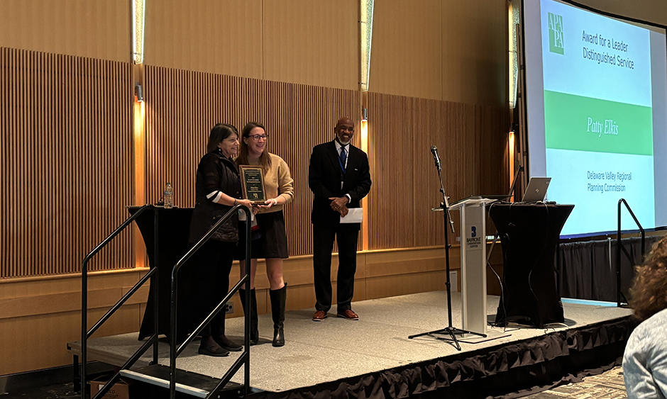 Patty Elkis is accepting her award on a stage