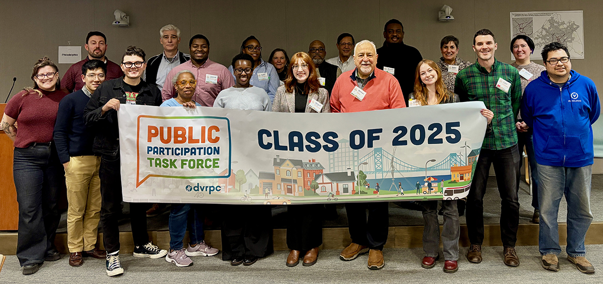 A group of people stand together holding a banner that says DVRPC Public Participation Task Force Class of 2025