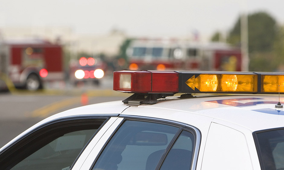 Police cars, fire trucks, and ambulances at a crash scene