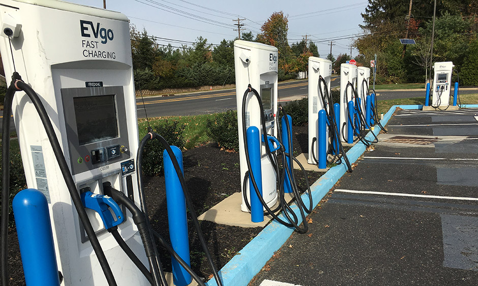 A row of electric vehicle charges in a parking lot
