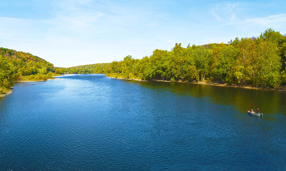 A river lined by green trees on both sides
