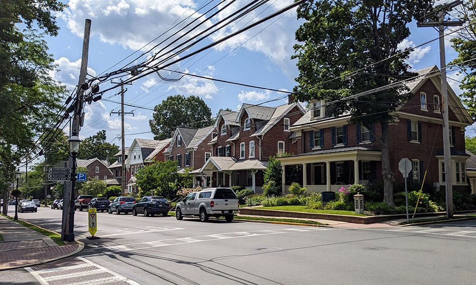 Houses on a residential suburban road. In the foreground is a crosswalk