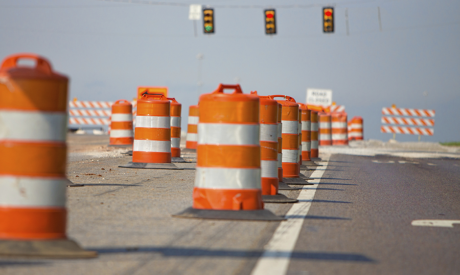 Orange construction barrels on a roadway