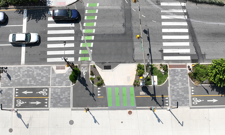 An aerial view of the Delaware River Trail, featuring a two-way bike path next to a sidewalk as well as painted crosswalks