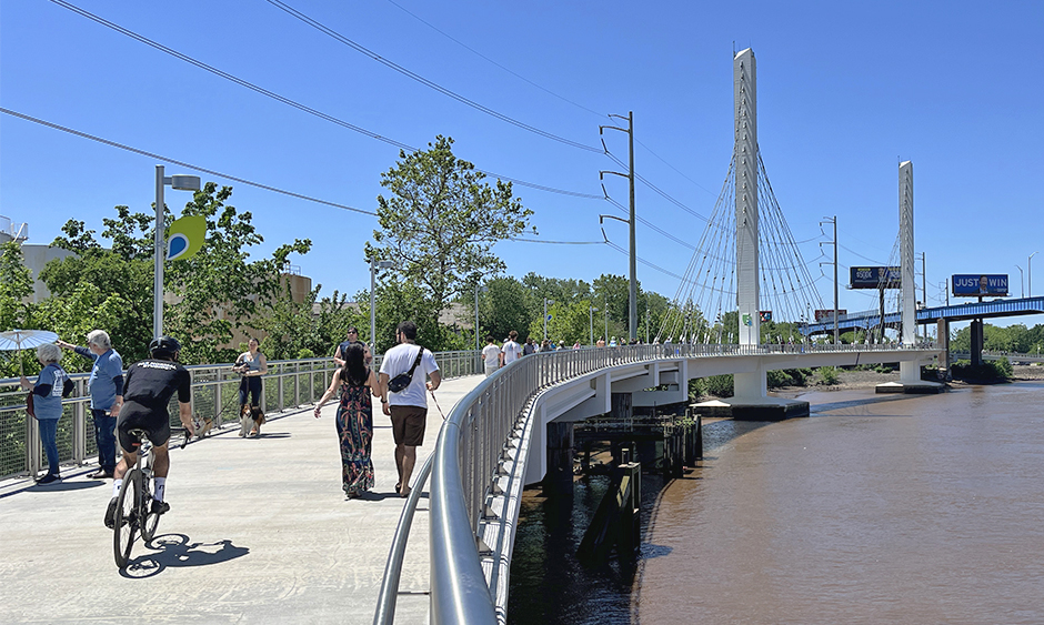 People walking and biking on a multi-use trail that crosses over the Schuylkill River in Philadelphia