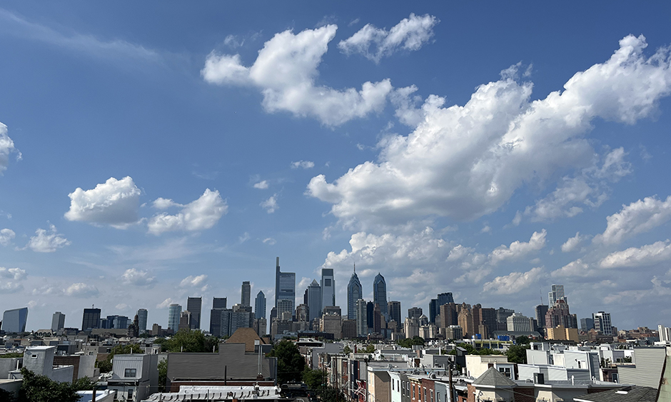 Big white clouds in a bright blue sky over the Philadelphia skyline